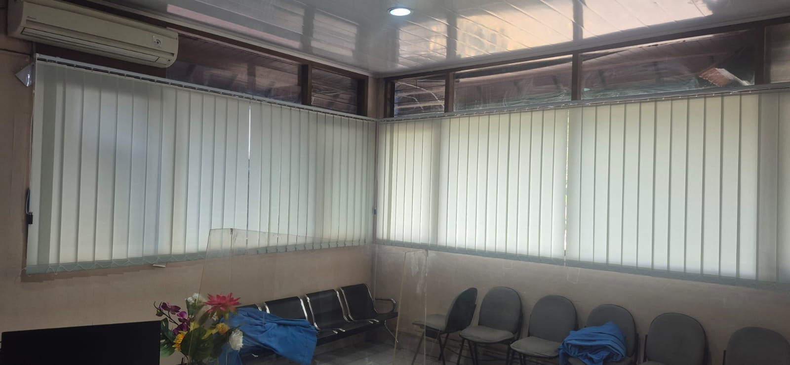 Tirai vertical blind bernuansa krem netral yang mengoptimalkan pengaturan cahaya, kerapian, dan kenyamanan area ruang tunggu.